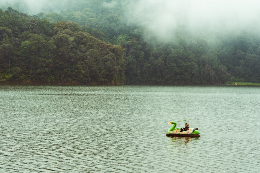 a person in a small boat on a large body of water