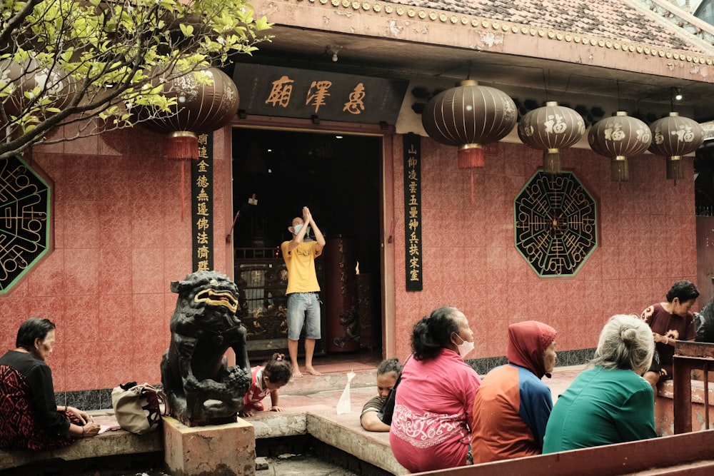 a group of people sitting outside of a building