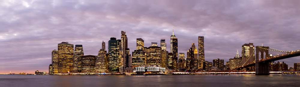 a city skyline with a bridge in the foreground