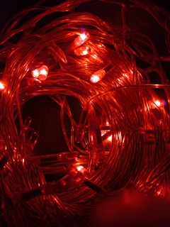 A close-up photo showing the vibrant colors and flexible design of Savlyt's LED rope lights glowing warmly in a dark setting.