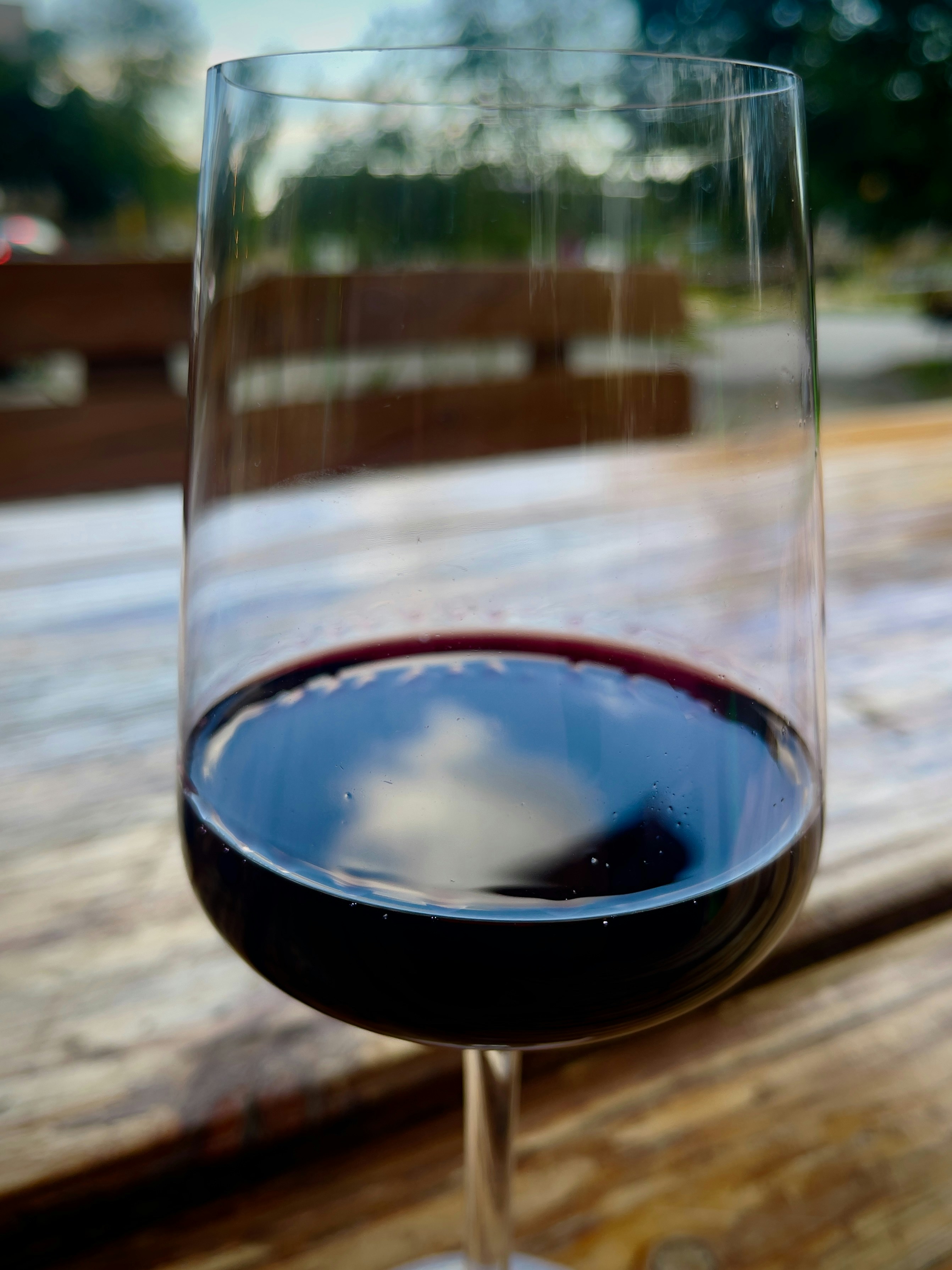 Glass of deep red Chianti wine against blurred restaurant background