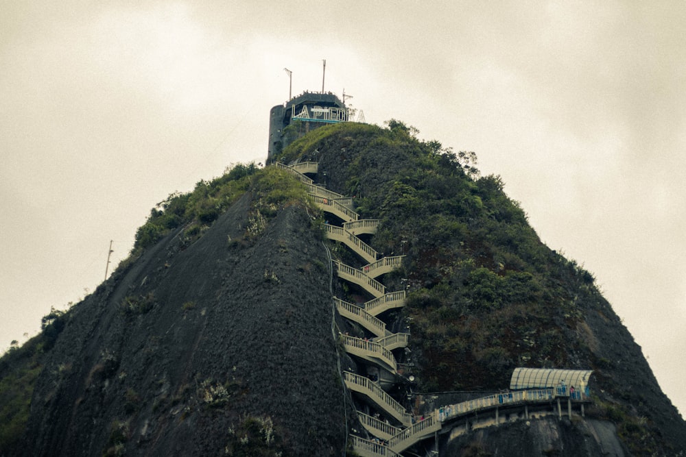 a very tall mountain with stairs going up it