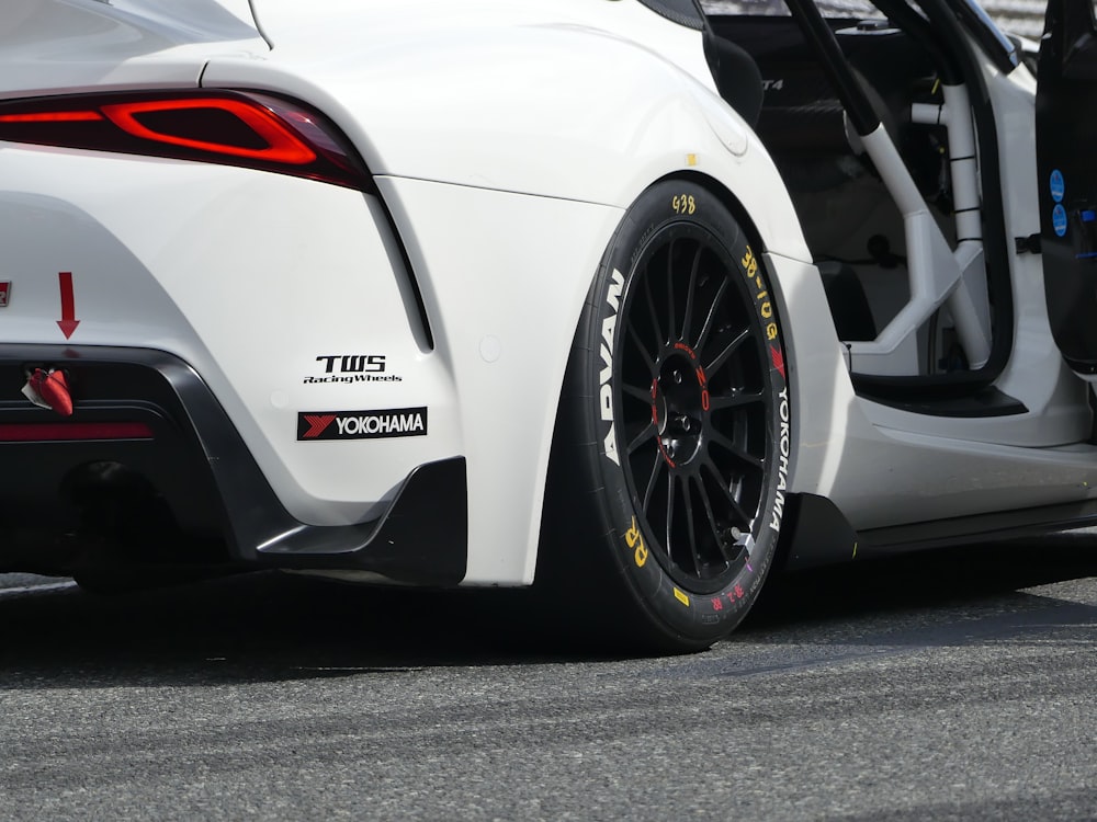 a close up of the rear end of a white sports car