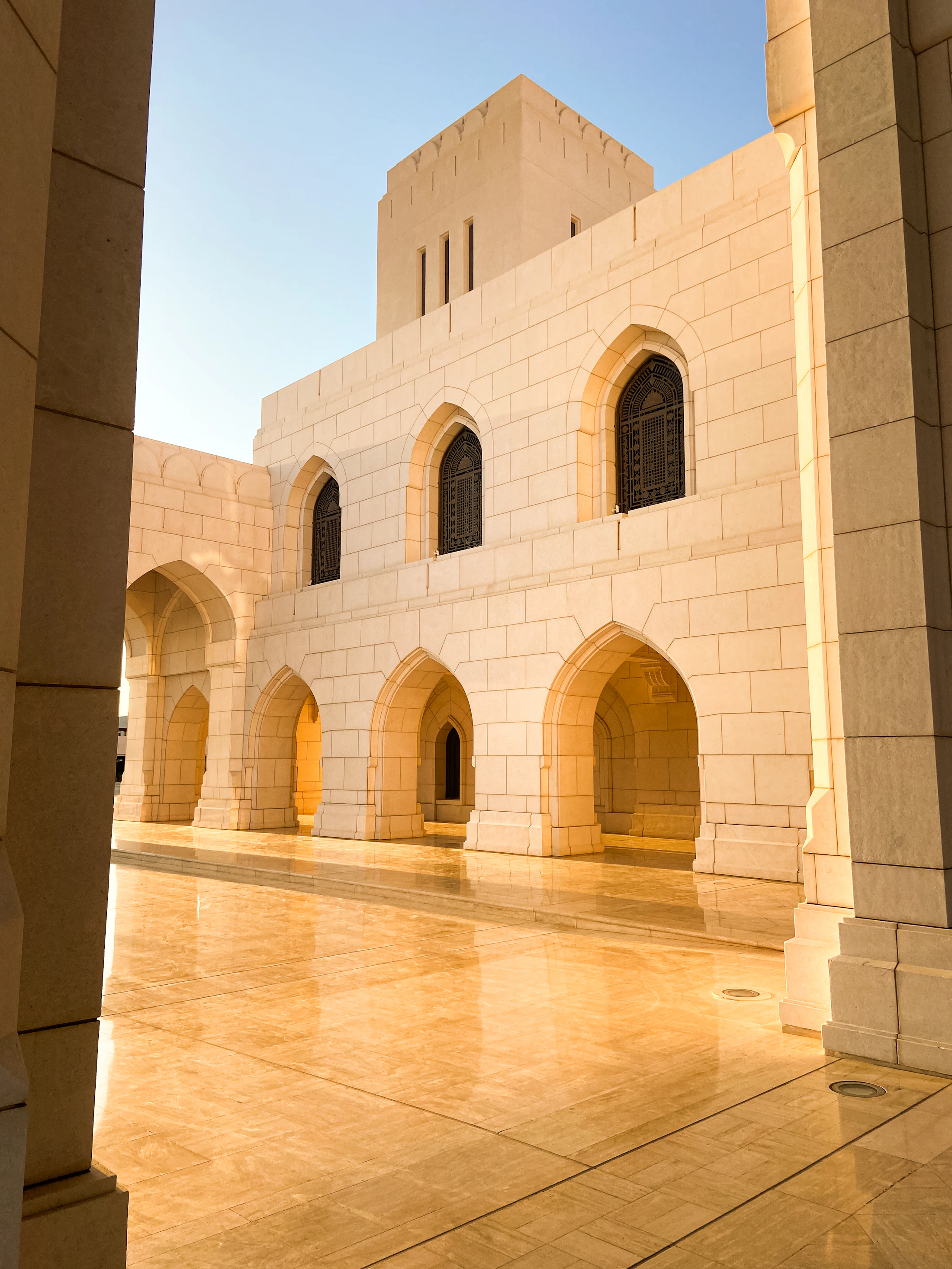 The white stone arches of the Royal Opera House Muscat