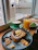 A cozy corner booth with a plate of steaming breakfast and a mimosa on the table.