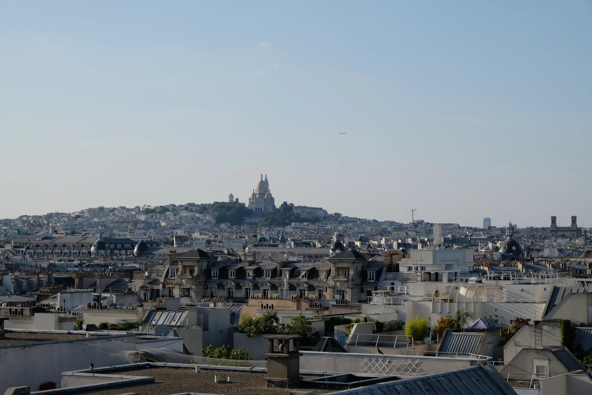 A panoramic view of Burao city from a hilltop, capturing the mix of traditional and modern buildings against a clear blue sky.