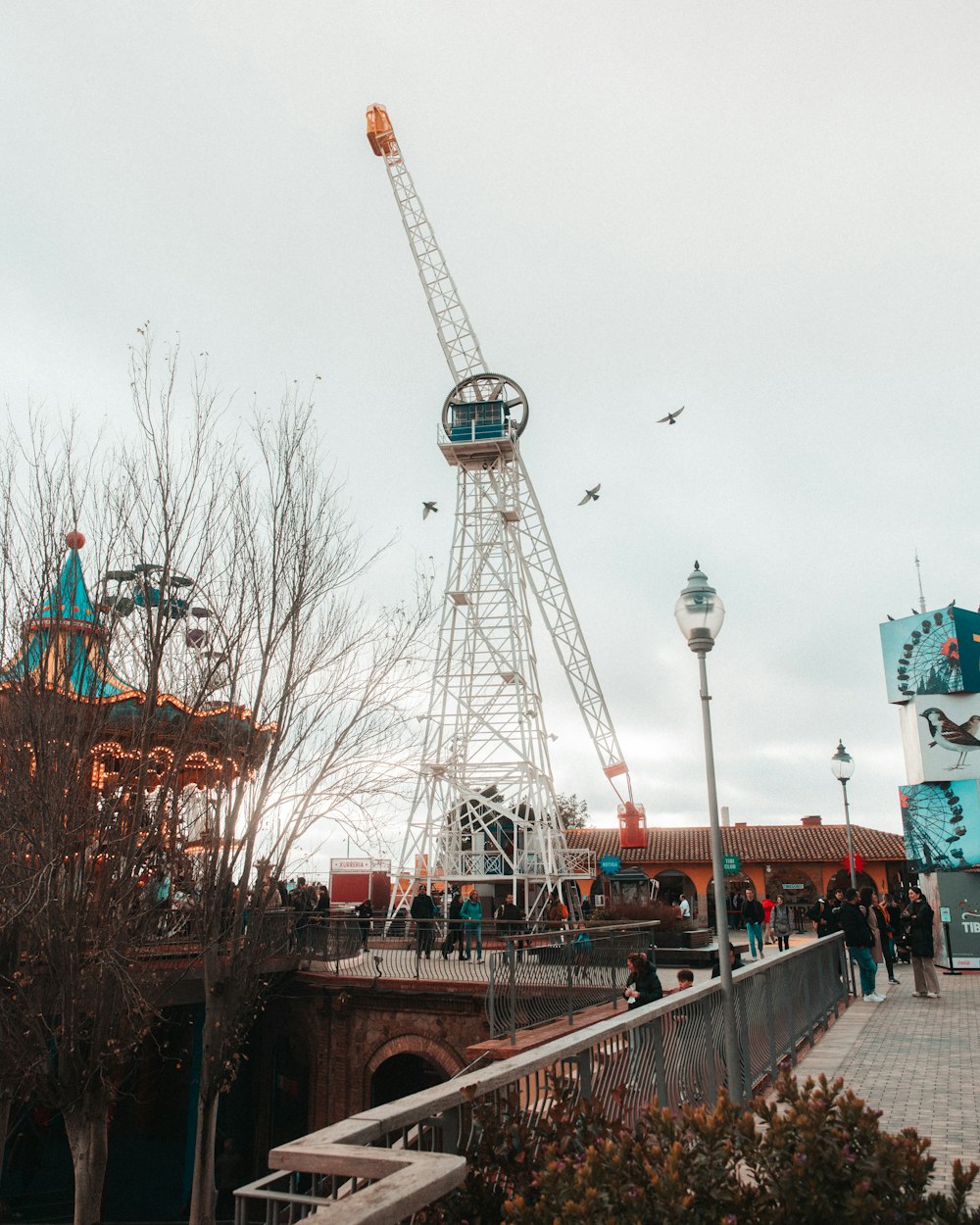 a ferris wheel sitting next to a bridge