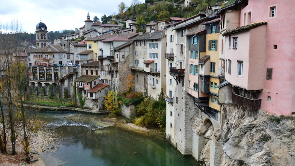 a river running through a city next to tall buildings