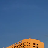 A commercial building with a newly replaced flat roof on a sunny day.