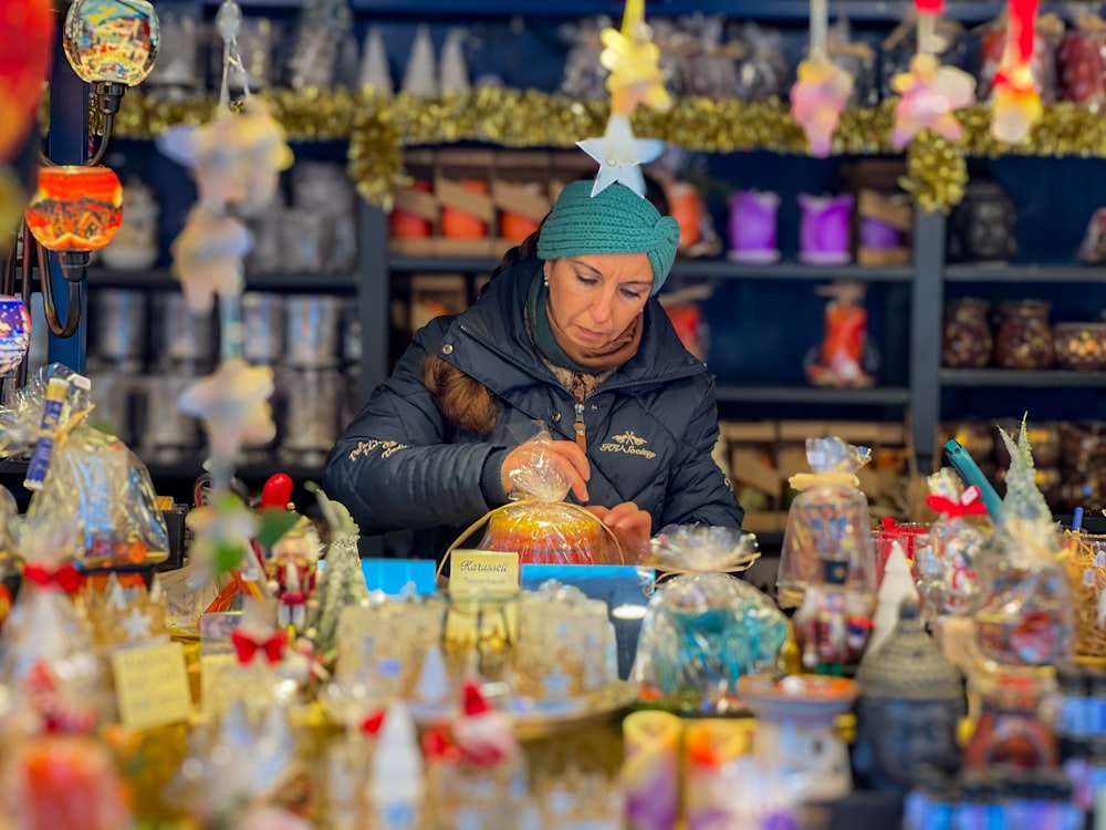 a woman looking at a glass ball in a store