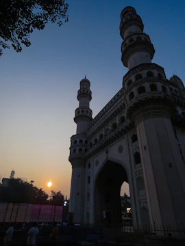 Photographers capturing the intricate details of a historic monument during golden hour.