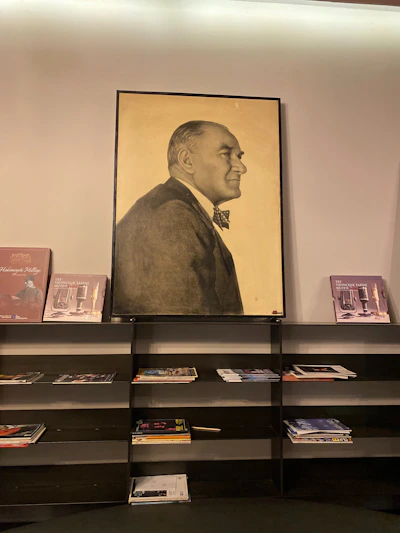 A warm, soulful portrait of Harry Berg at 85, seated in a classic library setting surrounded by books.