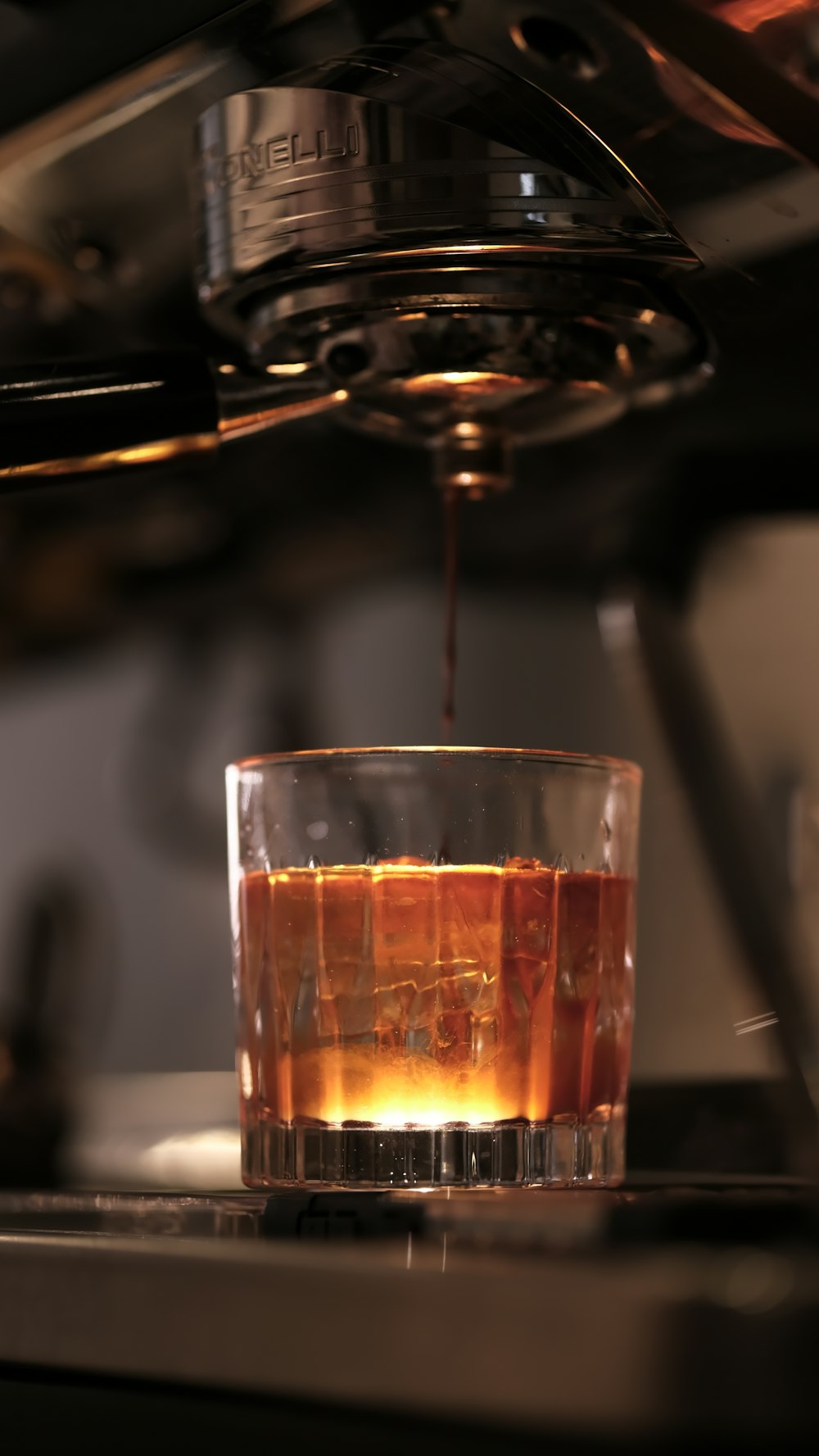 a glass filled with liquid sitting on top of a counter