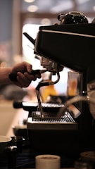 A professional coffee machine service technician working on a coffee machine.