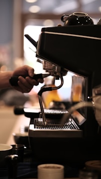 A professional coffee machine service technician working on a coffee machine.