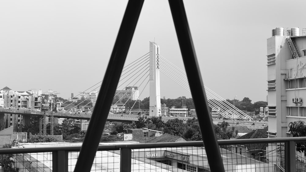 a black and white photo of a bridge and buildings