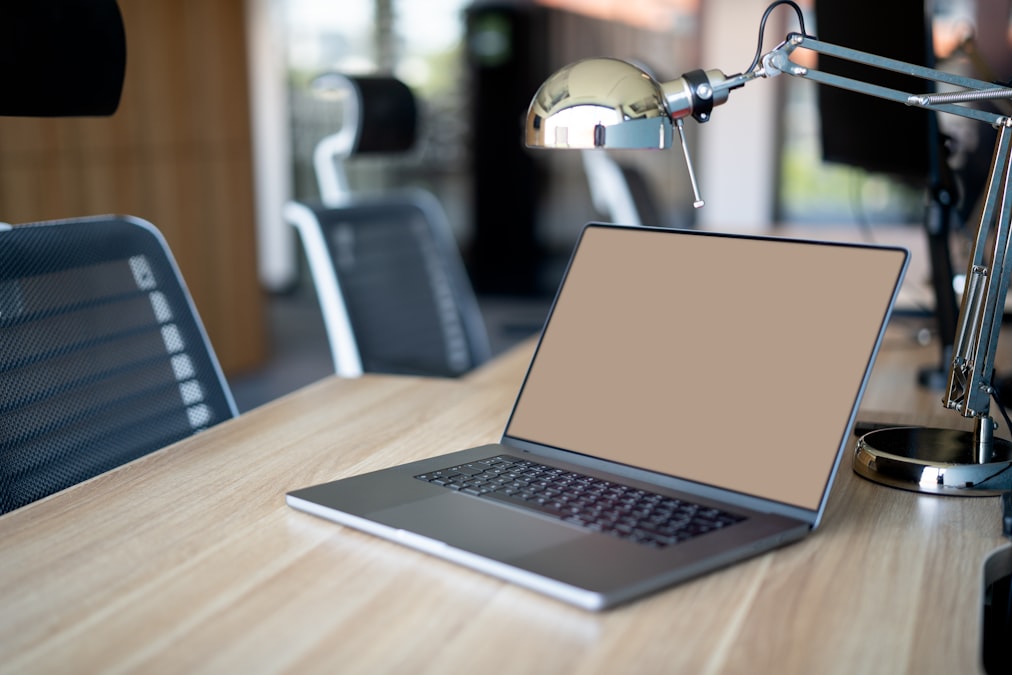 a laptop computer sitting on top of a wooden desk