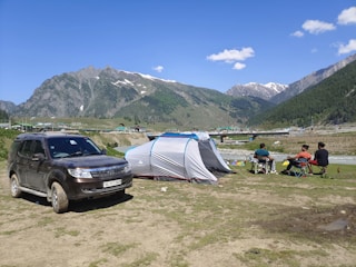 A family camping with a trailer in a scenic location.