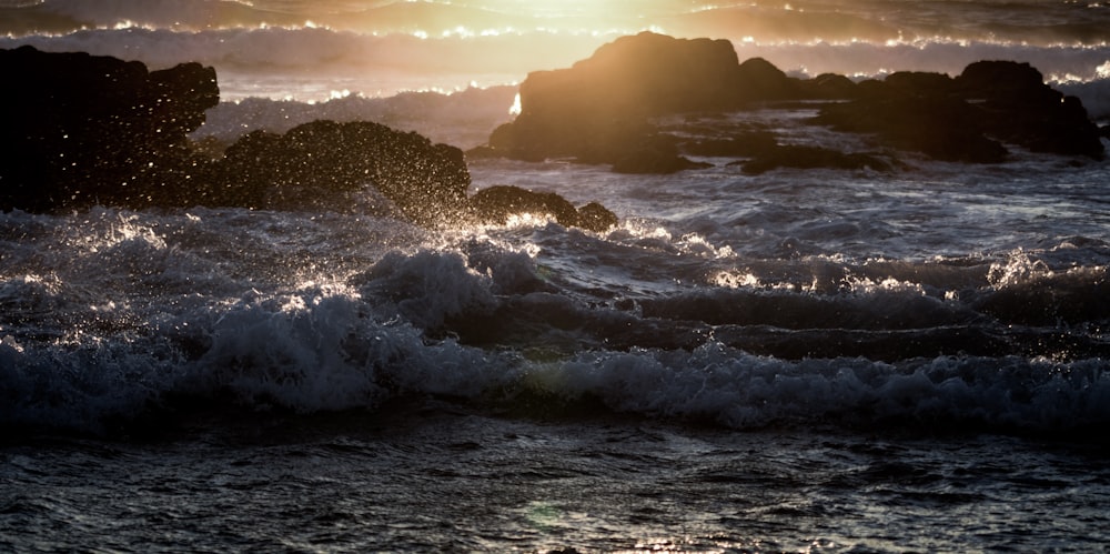 the sun is shining over the ocean waves