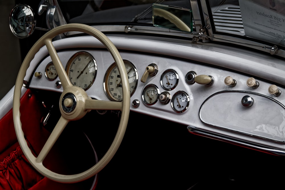 a car dashboard with a steering wheel and gauges