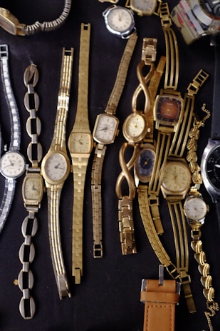 Collection of vintage watches displayed on a wooden surface.