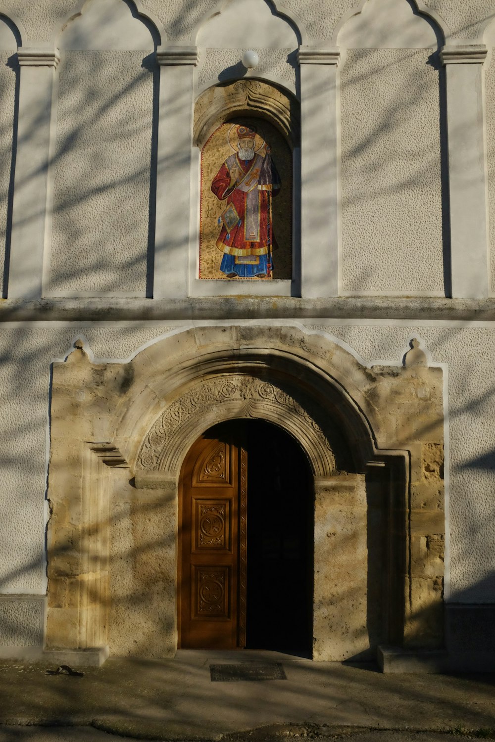 a large building with a wooden door and a stained glass window