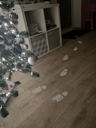 Close-up of evidence markers placed beside crucial clues on a wooden floor.
