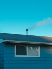 Cozy new residential home exterior under a bright blue sky.