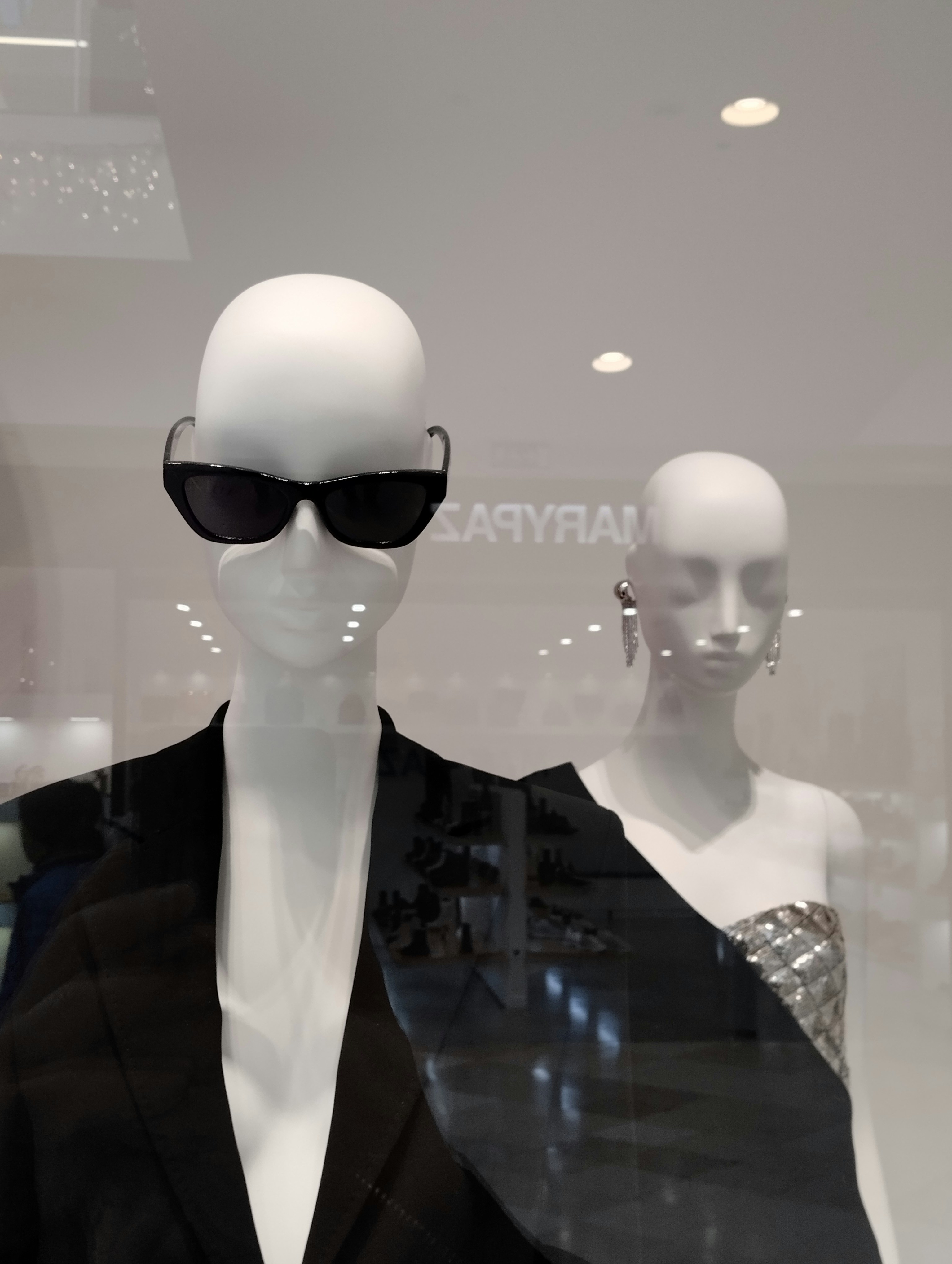 a mannequin wearing sunglasses and a black jacket