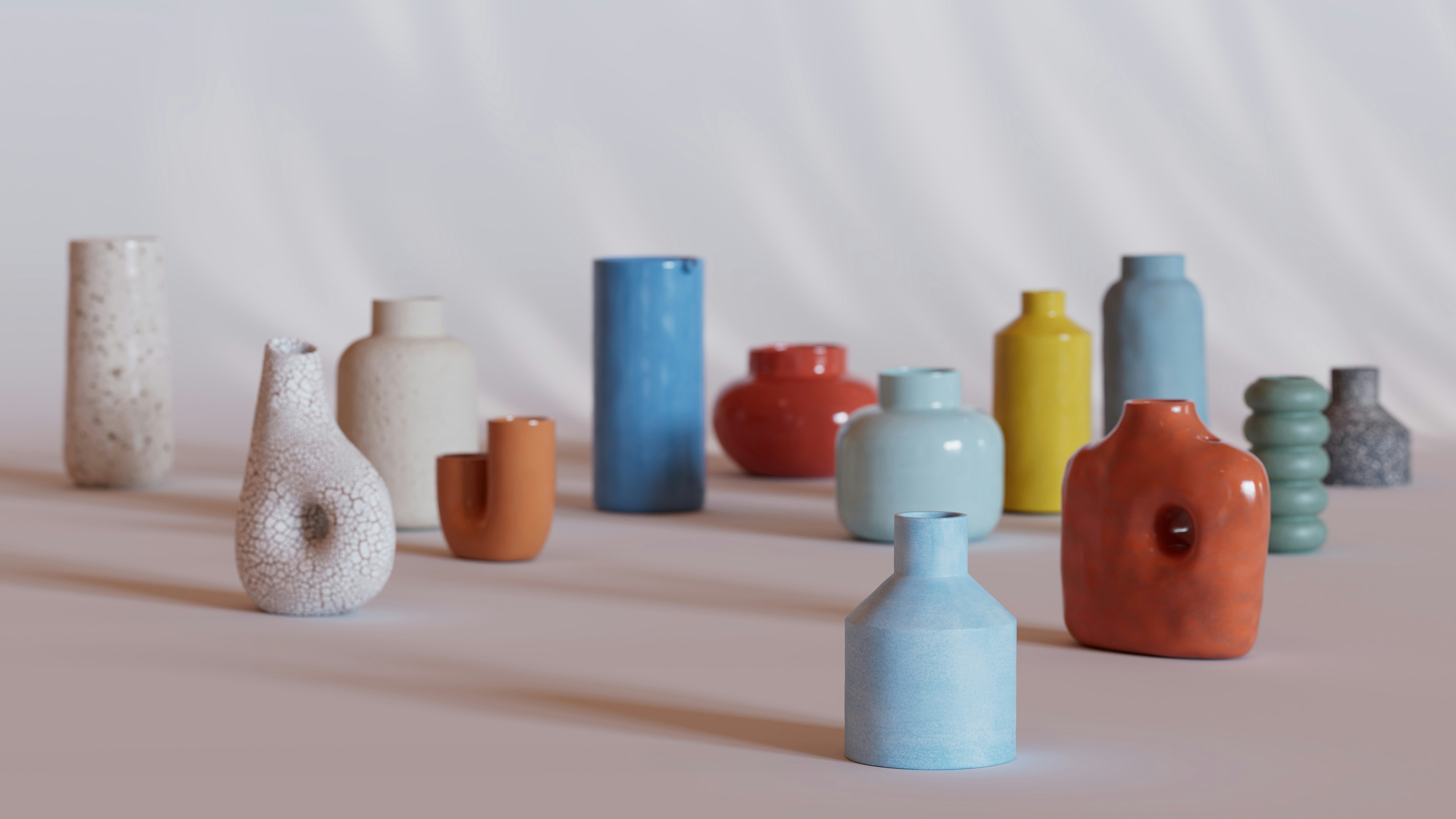 A collection of colorful pottery pieces, most of which could be vases or simply aesthetic designs.