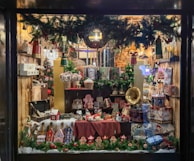 A festive display window decorated with seasonal sale signs and attractive merchandise.