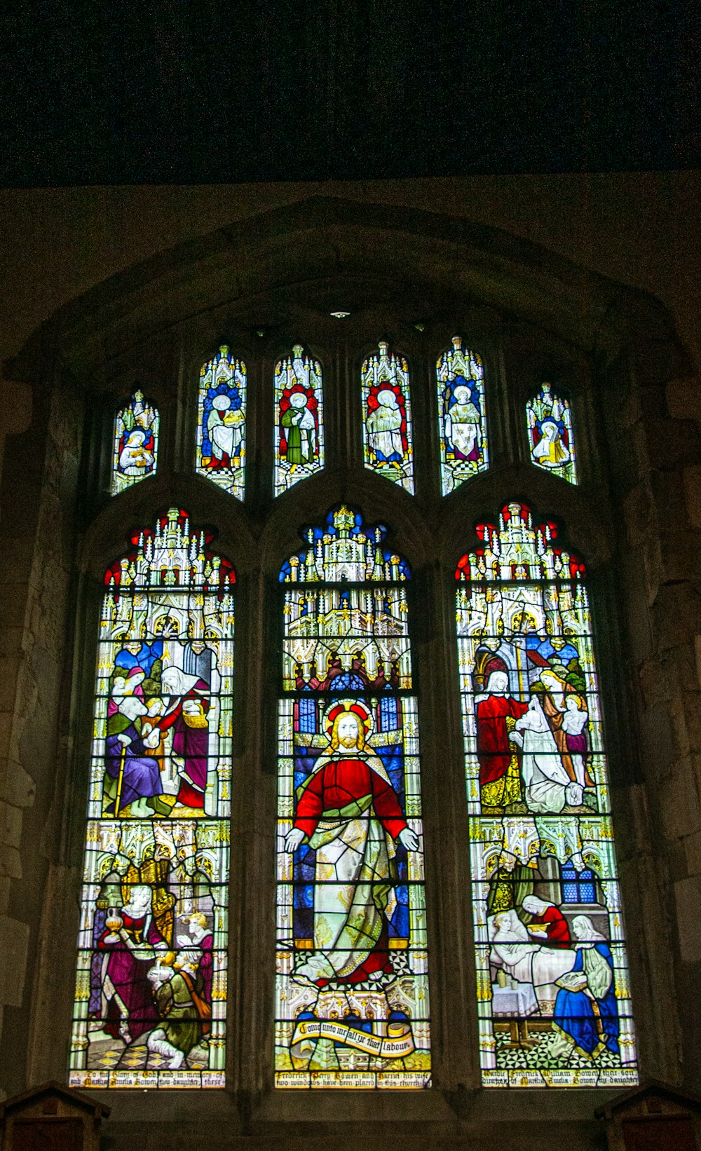 a large stained glass window in a church