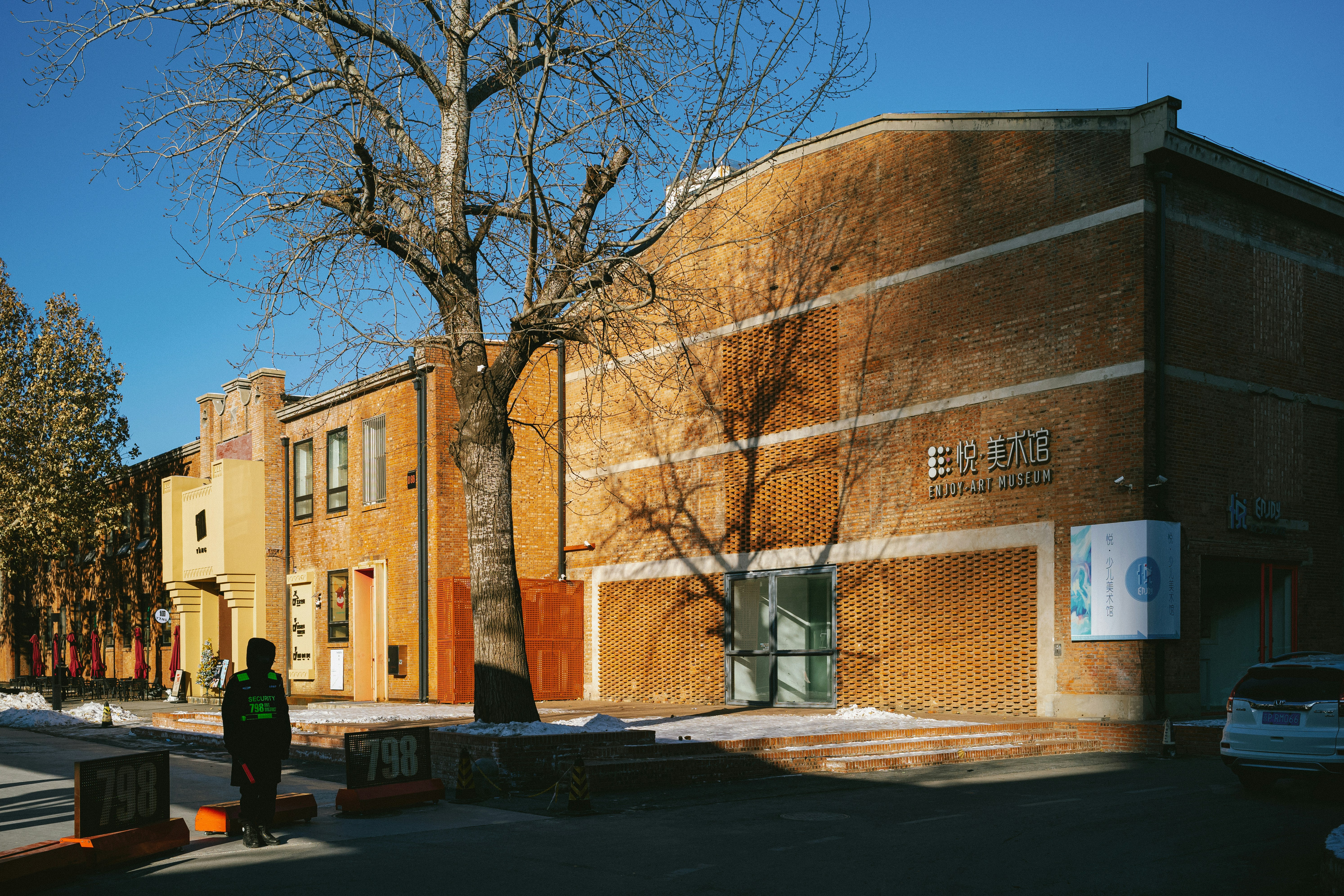a person standing in front of a brick building