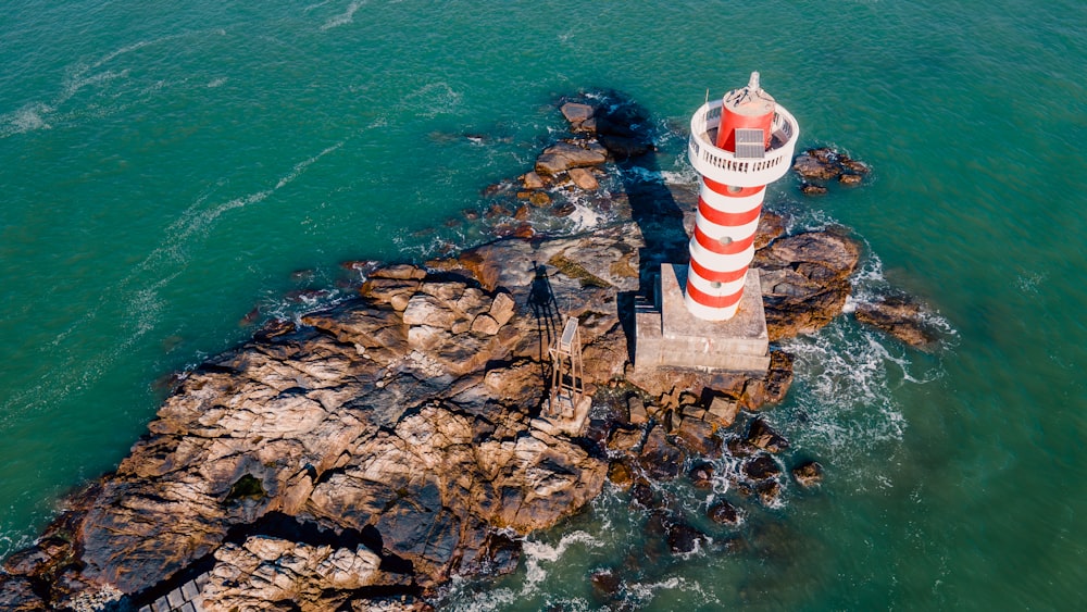 an aerial view of a lighthouse in the ocean