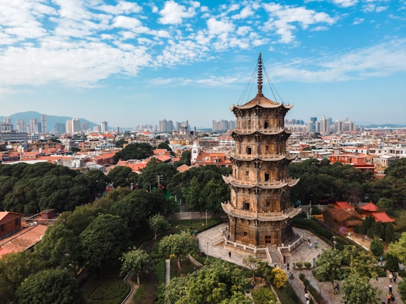 a tall tower sitting in the middle of a lush green forest