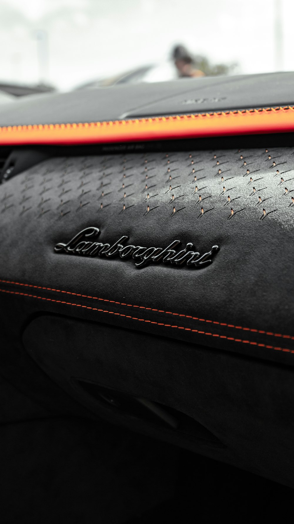 a close up of a black and orange leather seat