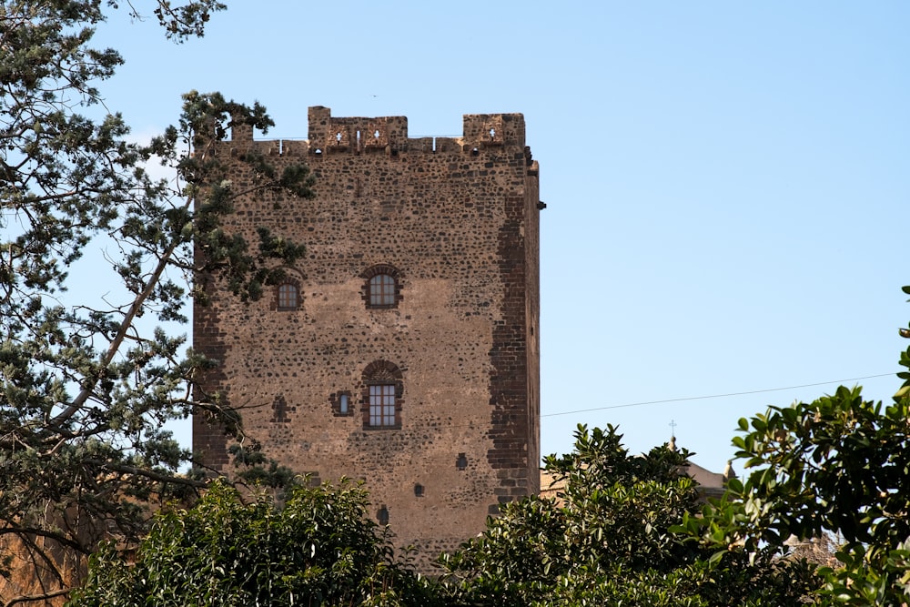 a tall brick tower with two windows on top of it