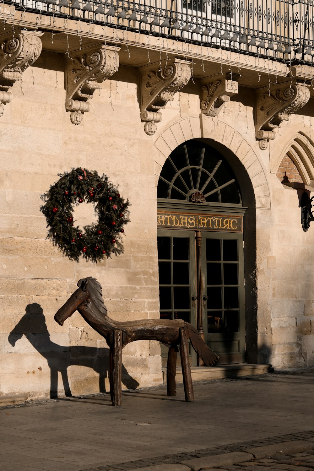 a statue of a horse and a dog in front of a building