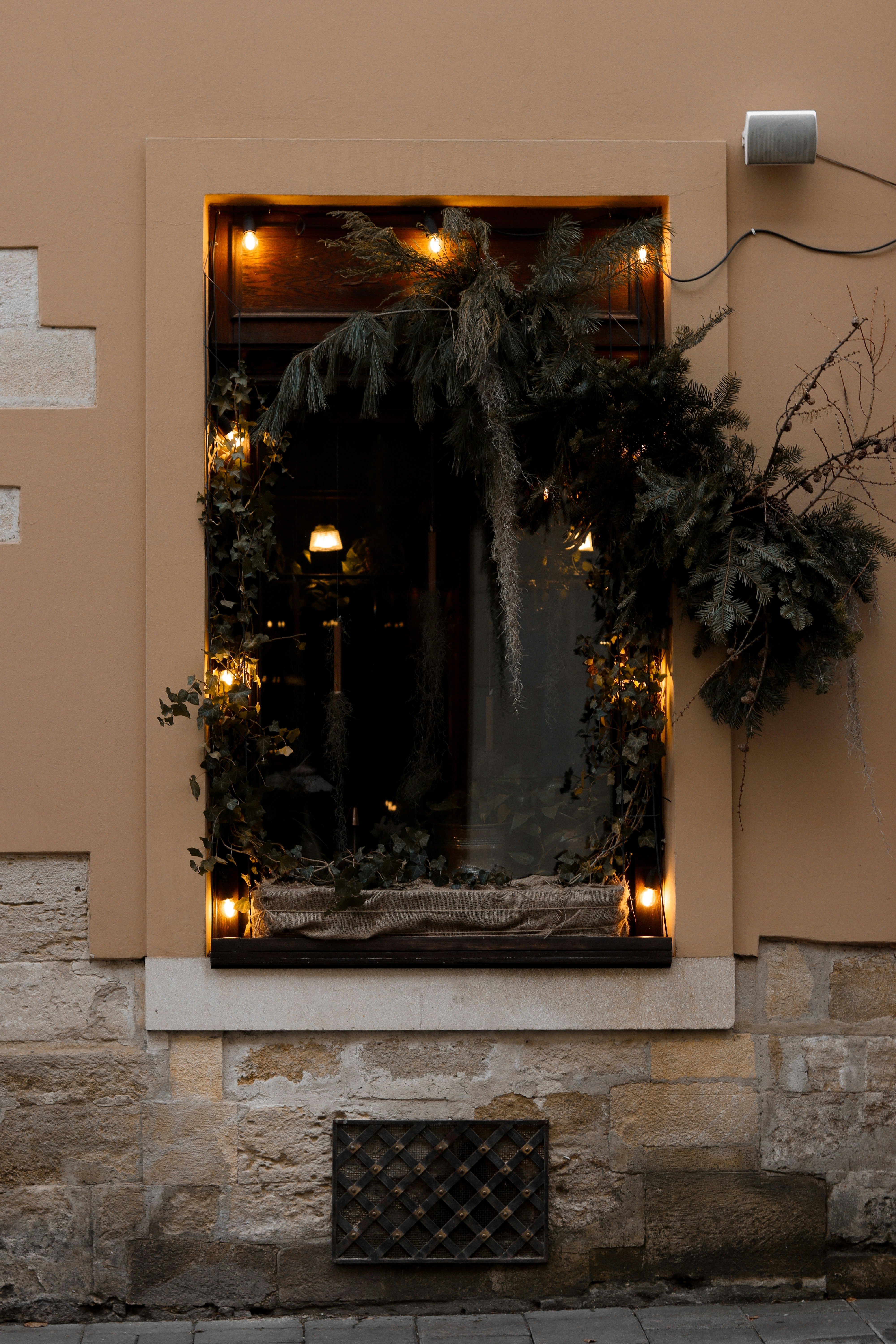 a building with a window decorated with christmas lights
