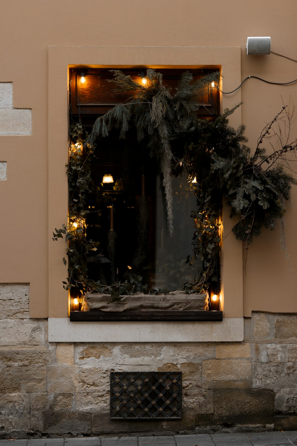 a building with a window decorated with christmas lights