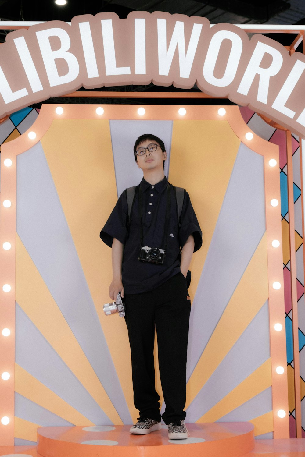 a man standing in front of a giant sign