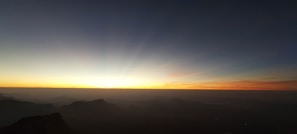 A beautiful sunrise over a peaceful mountain range.