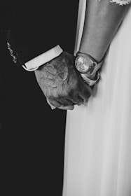 A still from a documentary-style film showing a close-up of hands holding a cherished memento.