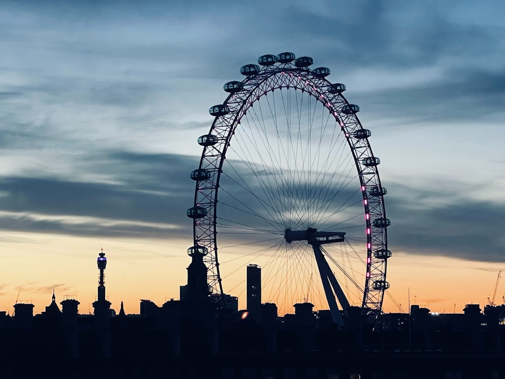 a large ferris wheel in the middle of a city