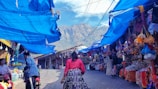 A vibrant Bolivian market bustling with locals and tourists under colorful tents