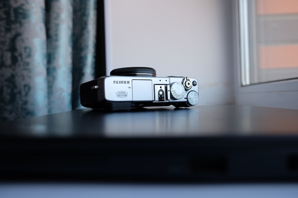 a camera sitting on top of a table next to a window