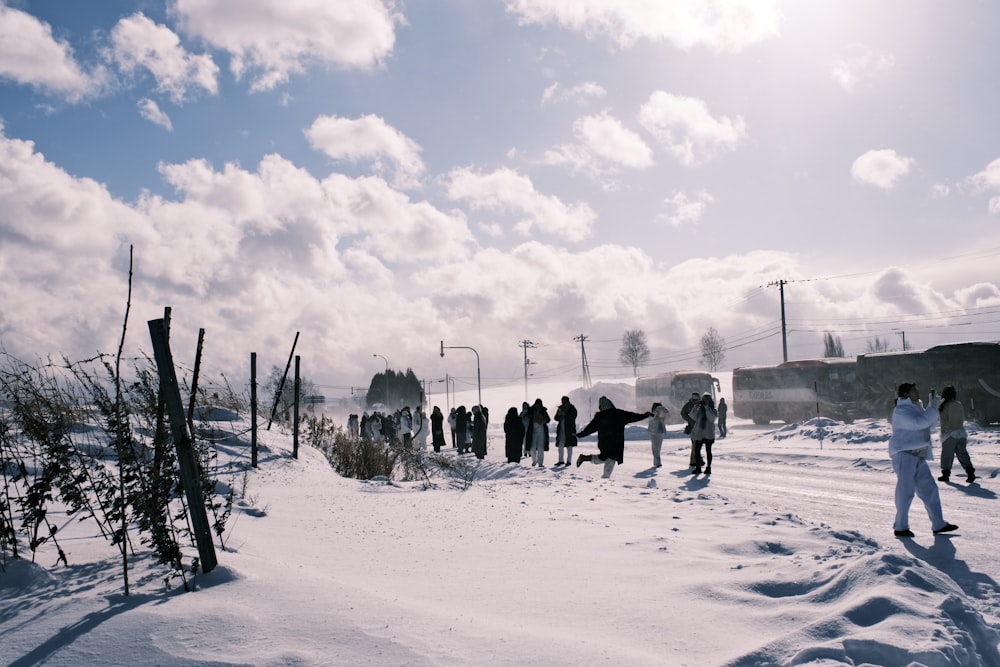 a group of people standing on top of a snow covered slope