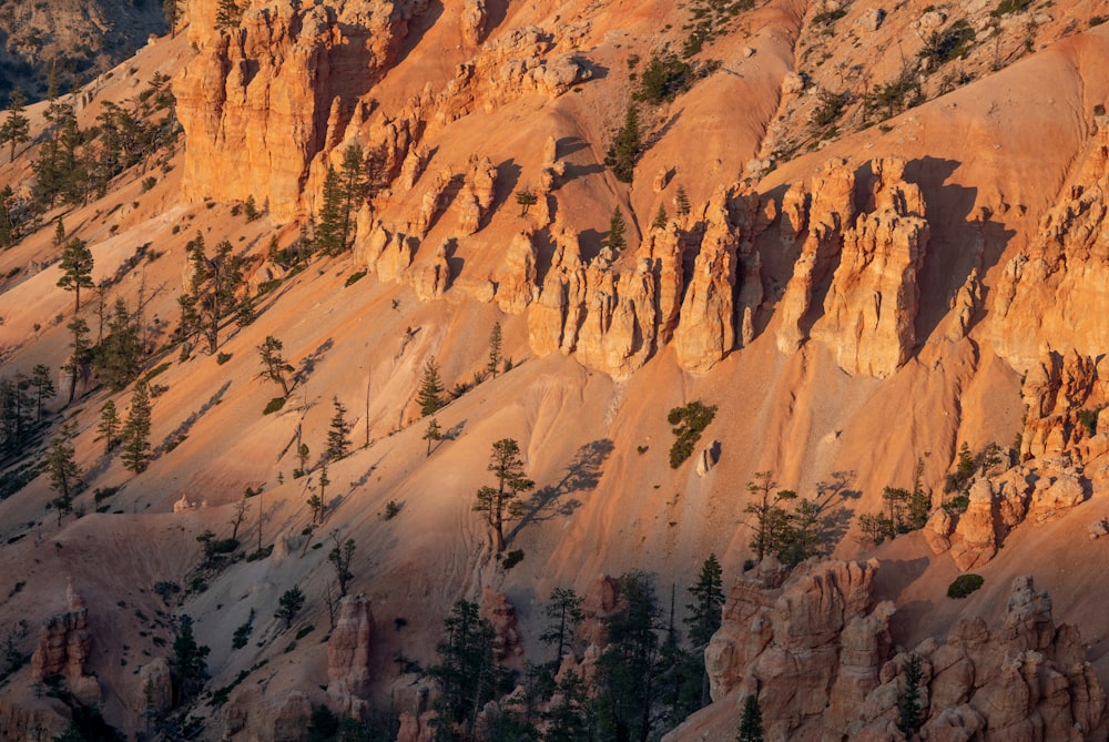 the sun is setting on a rocky mountain