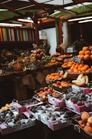 Baskets filled with fresh dates and vibrant citrus fruits at a market.