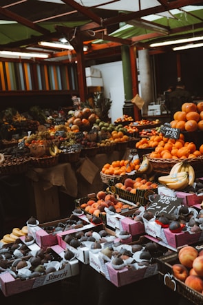 Baskets filled with fresh dates and vibrant citrus fruits at a market.